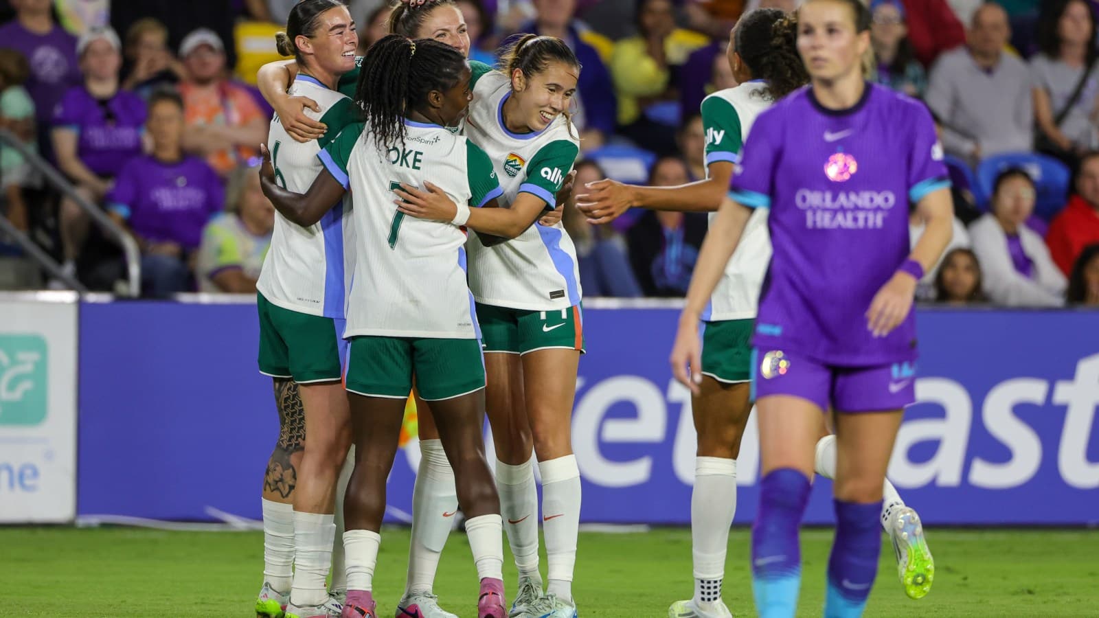 Players celebrating a goal during NWSL match