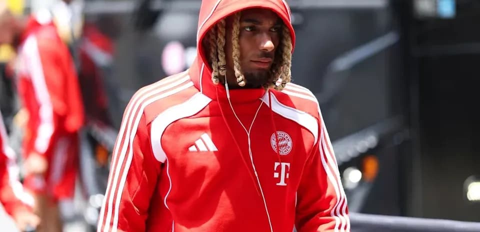 Player in red Bayern Munich tracksuit walking