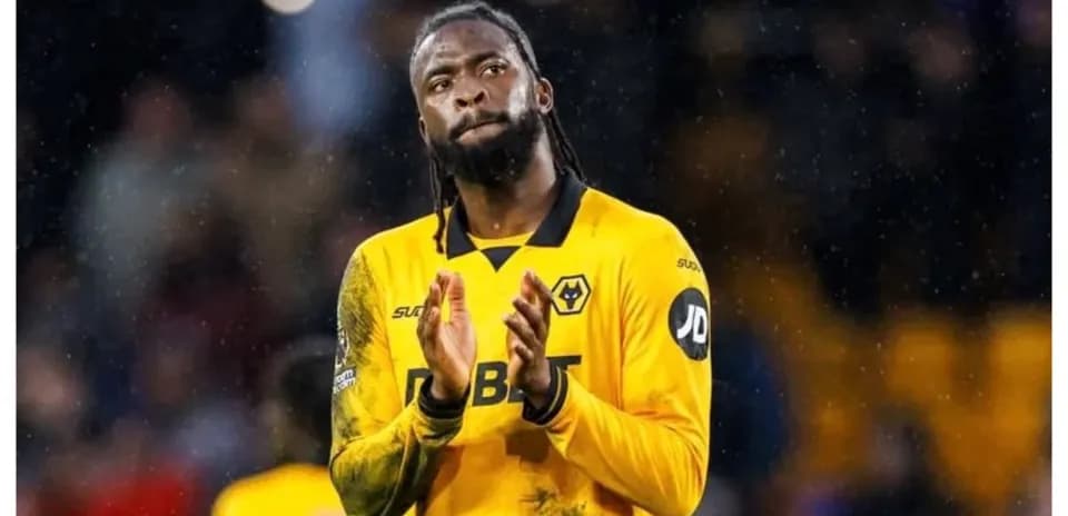 Player in yellow kit applauding fans after match