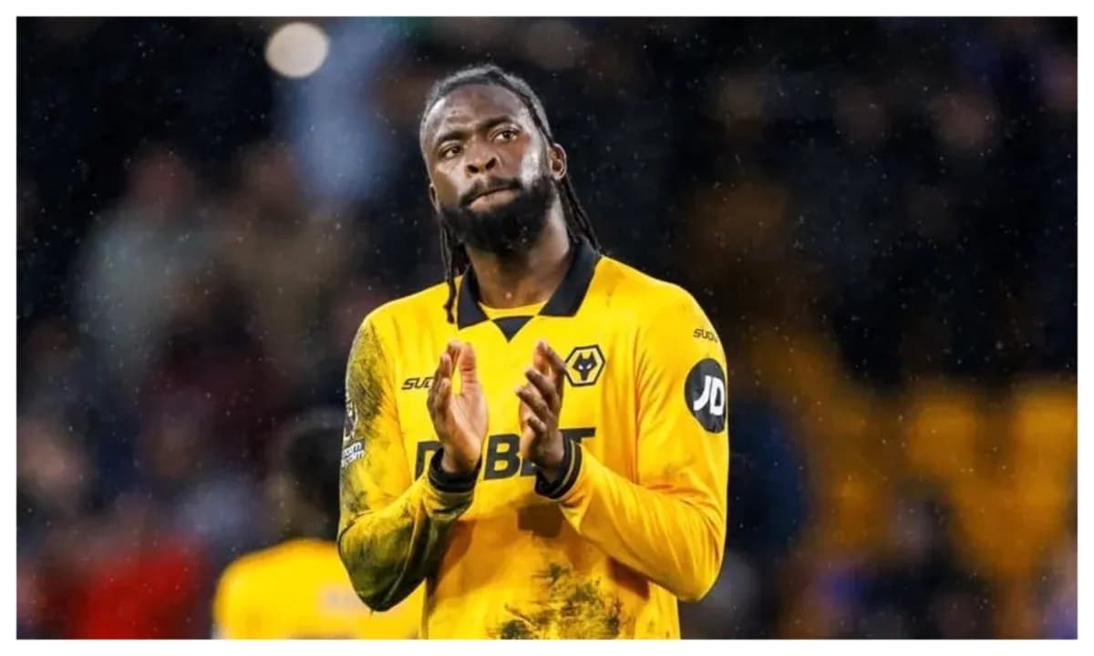 Player in yellow kit applauding fans after match
