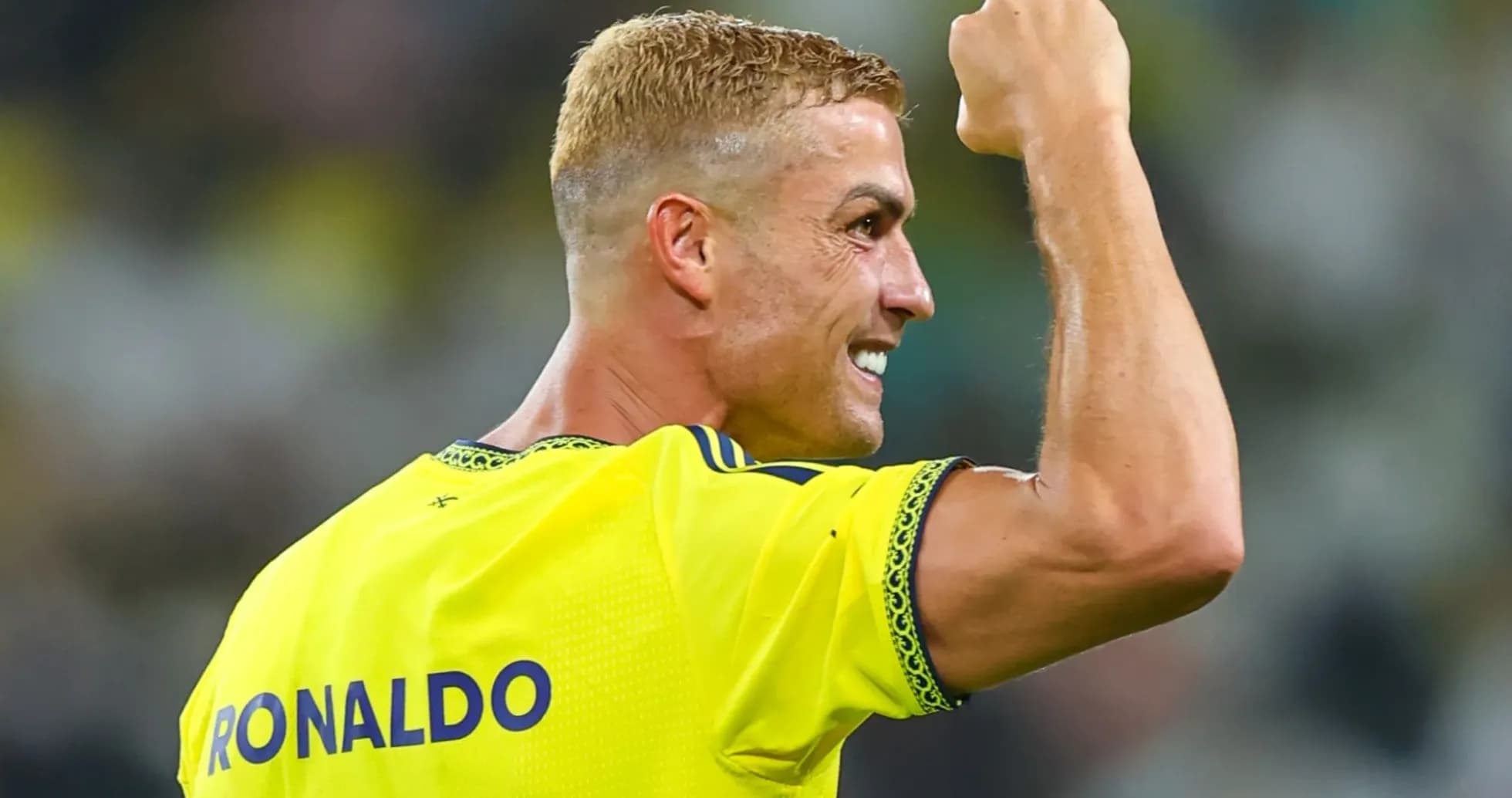 Player celebrating with raised fist on field