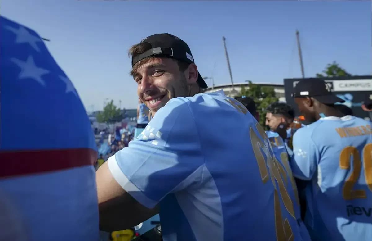 Player smiling during celebratory event in team jersey
