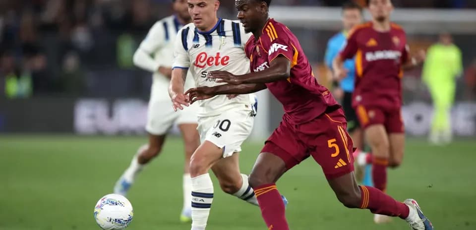 AS Roma player challenging Atalanta opponent for ball
