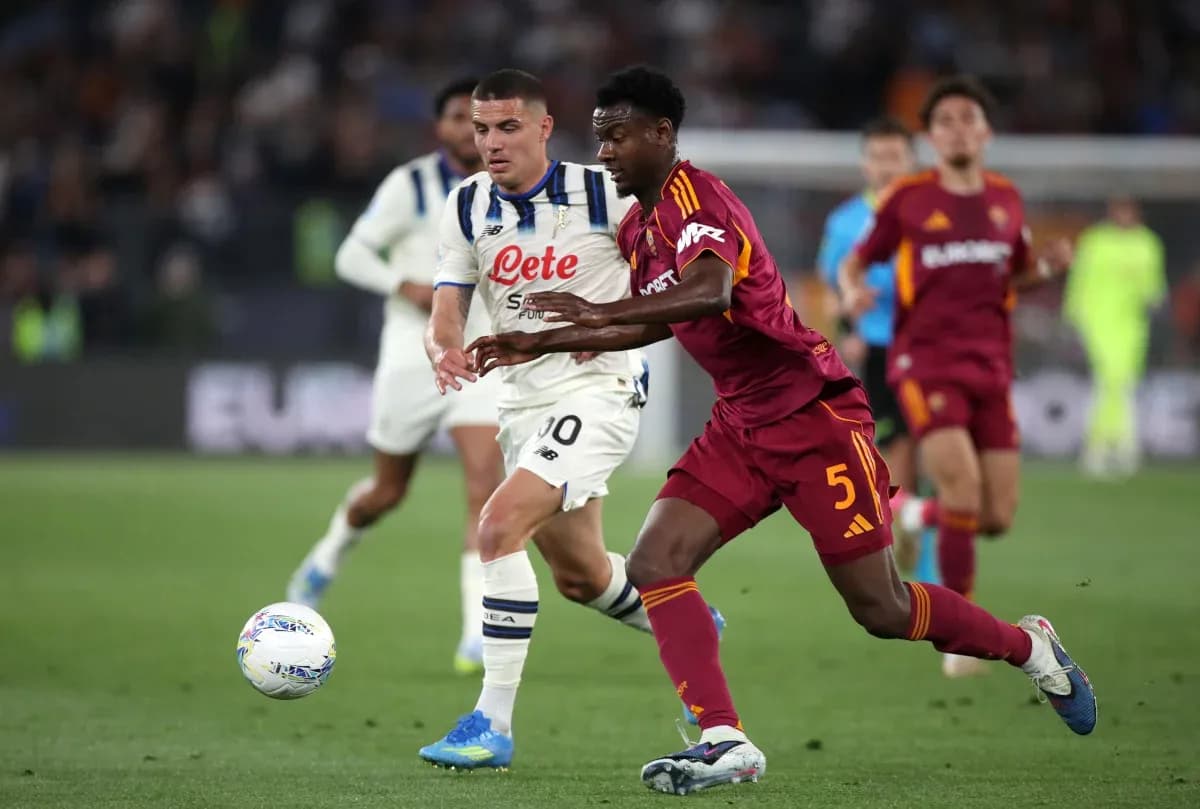 AS Roma player challenging Atalanta opponent for ball