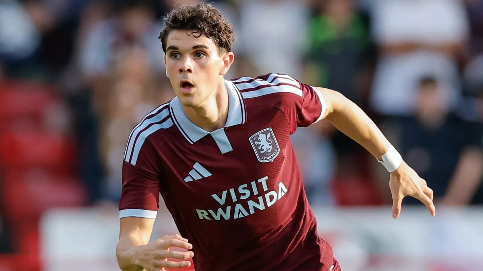 Player running during a football match for Aston Villa