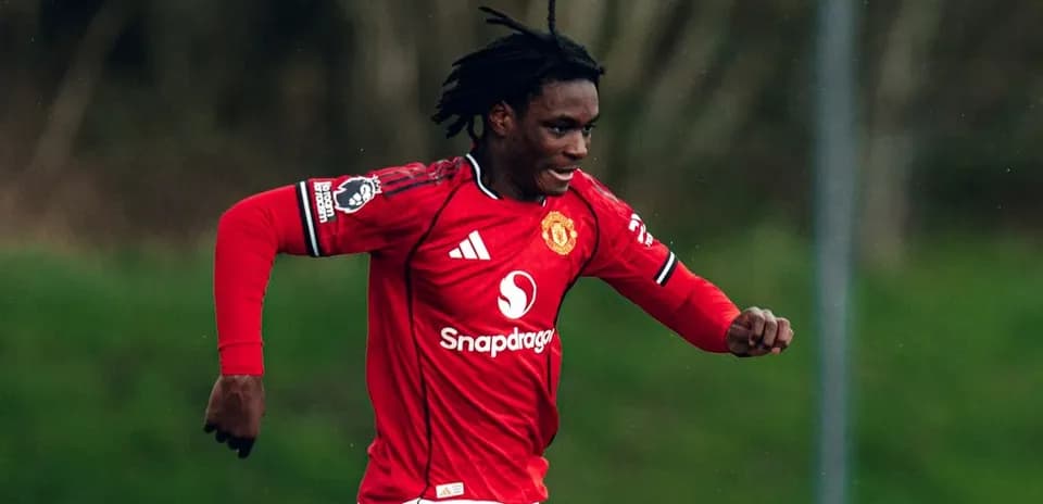 Player in red Manchester United jersey running on field