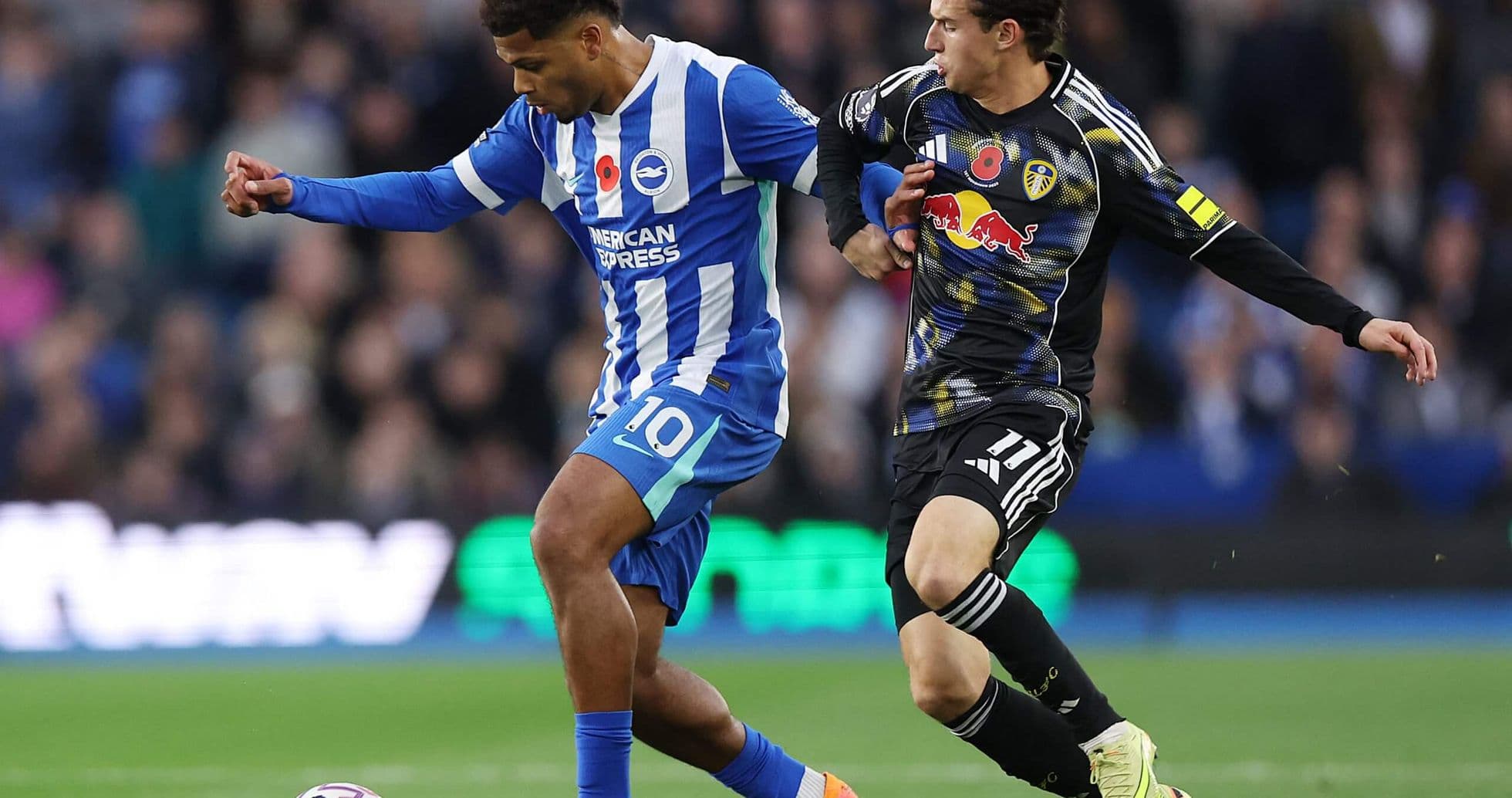 Brighton player dribbling past Leeds defender