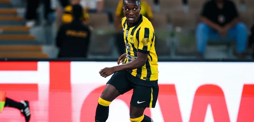 Player in yellow and black kit during match
