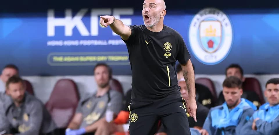 Coach giving instructions from the sidelines during match