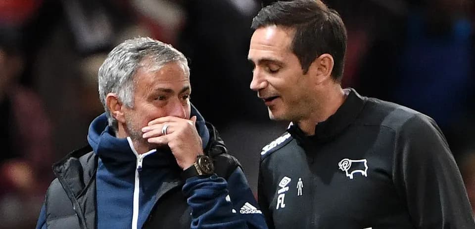 Two football managers talking on the sidelines