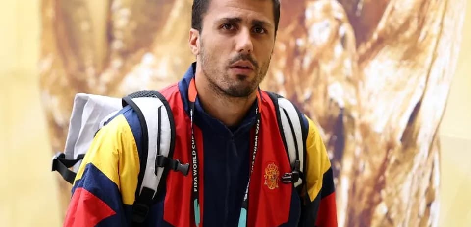 Athlete wearing team jacket with backpack indoors