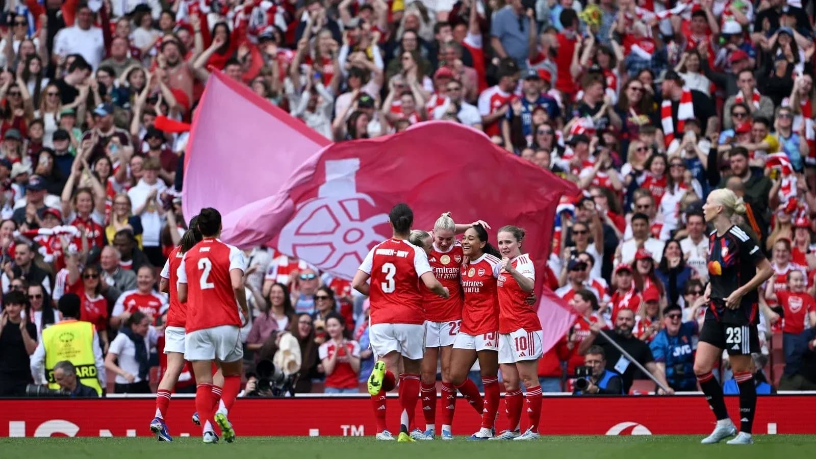 Arsenal players celebrating a goal with fans