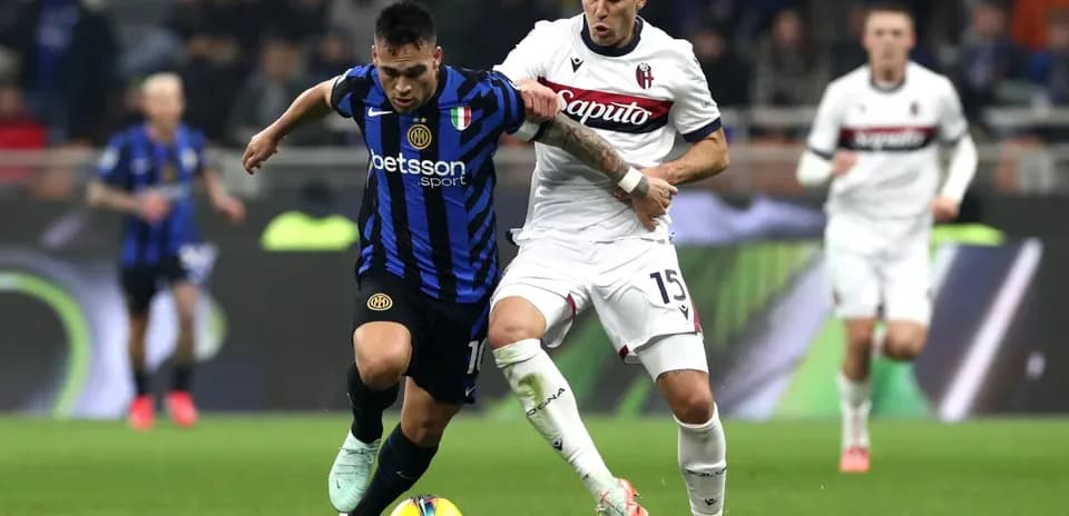Lautaro Martinez and player battling for possession