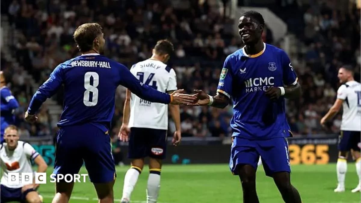 Two players celebrating a goal on the field