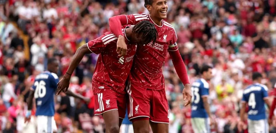 Two Liverpool players celebrating a goal together
