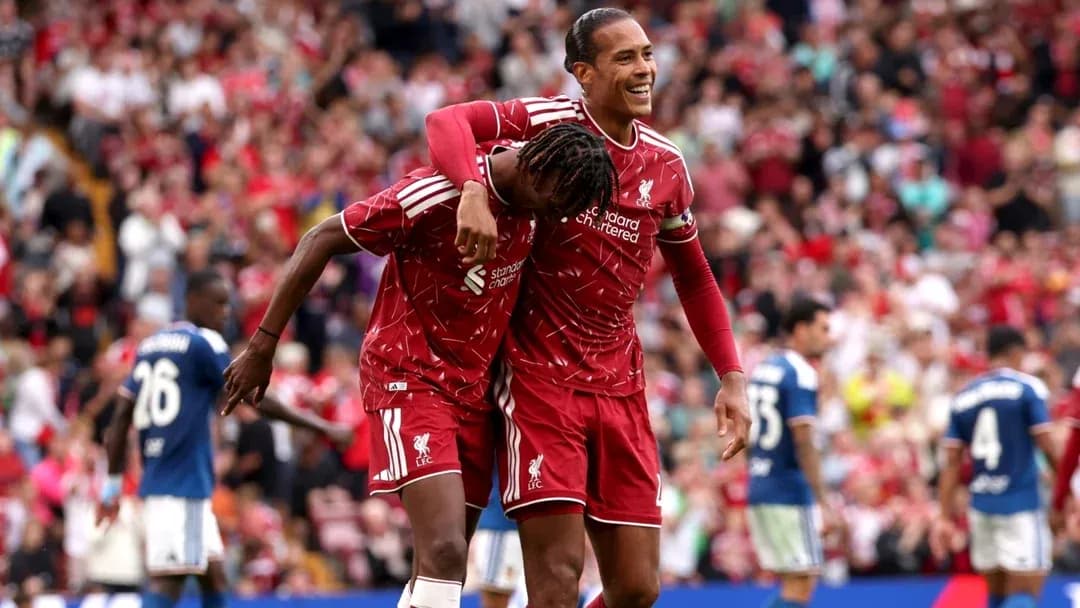 Two Liverpool players celebrating a goal together