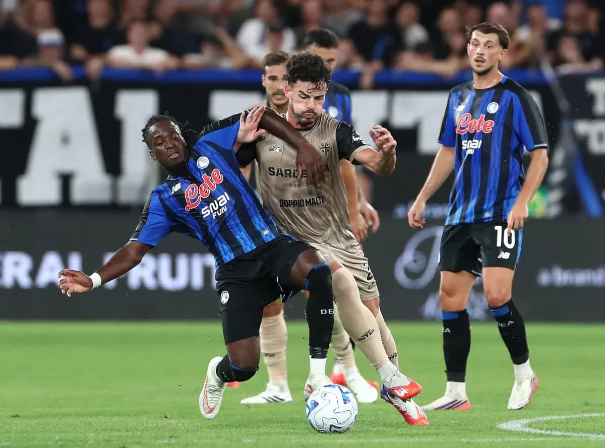 Atalanta player tackling Cagliari opponent in match