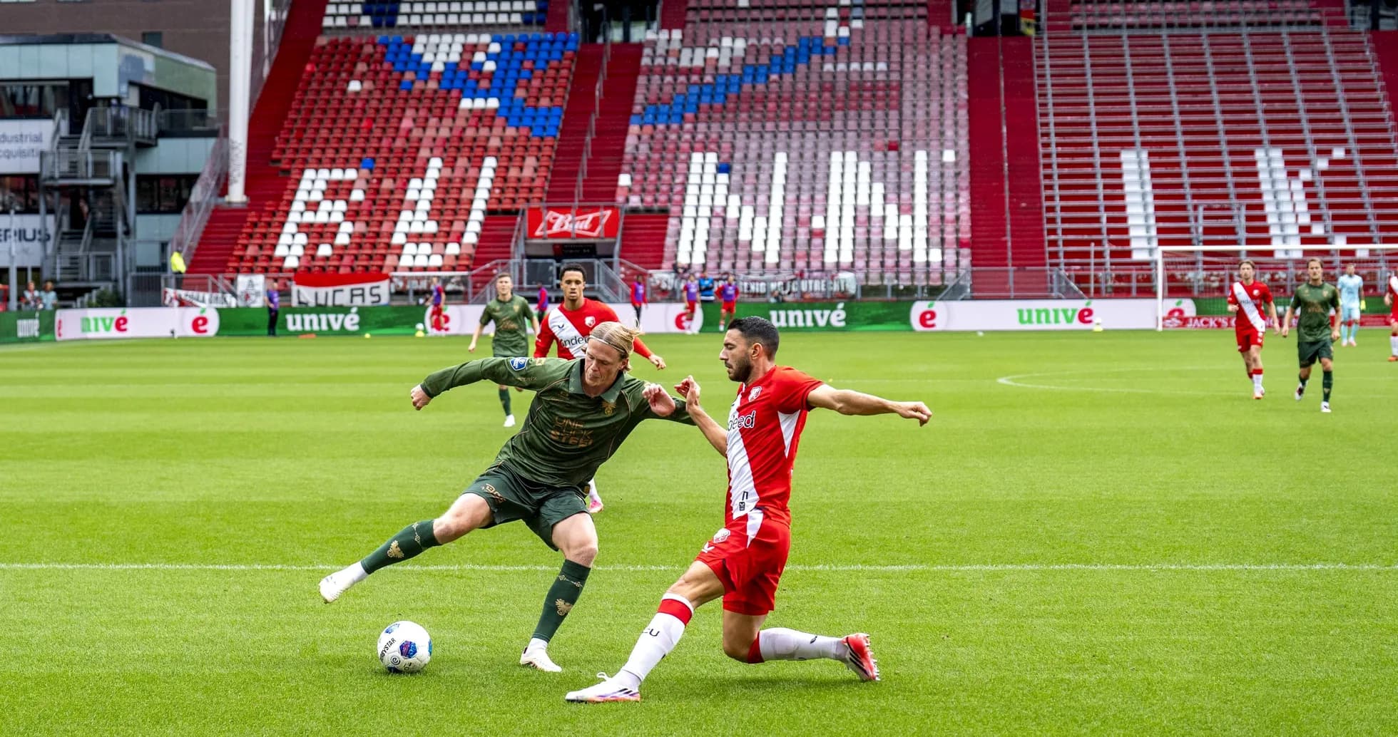 Two players contesting for the ball on the field