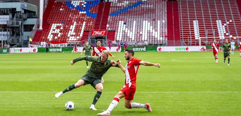 Two players contesting for the ball on the field