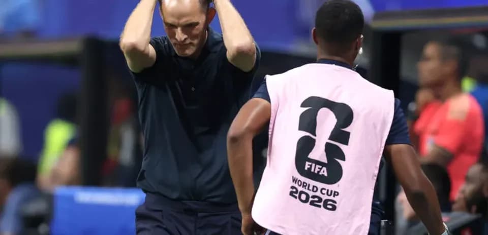 Coach with hands on head during match