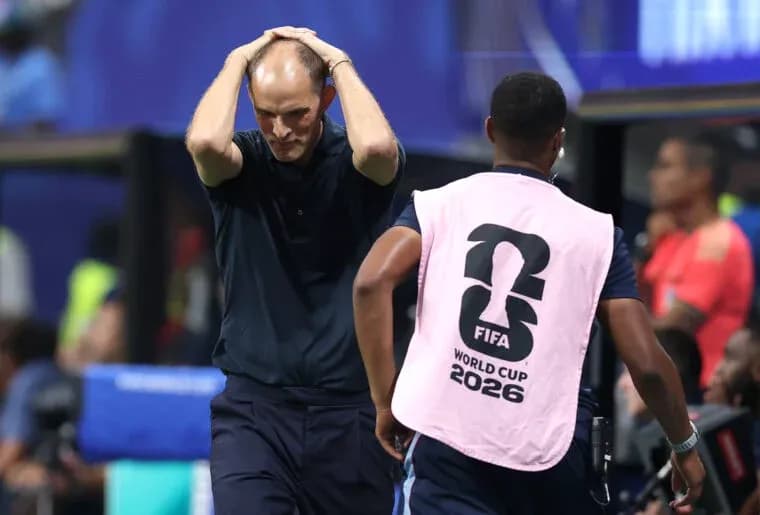 Coach with hands on head during match