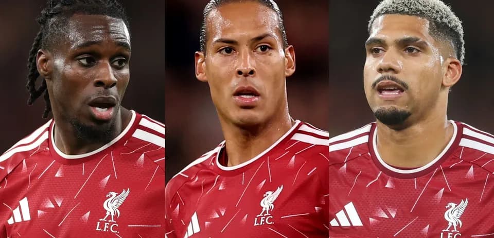 Three Liverpool players in red jerseys during match