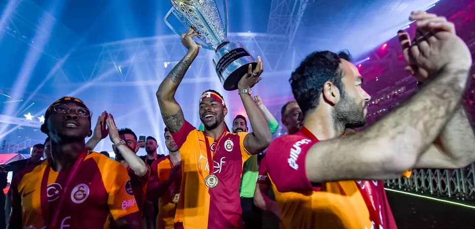Player celebrating with trophy during victory parade