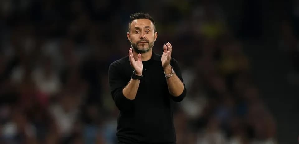 Coach applauding from the sideline during match