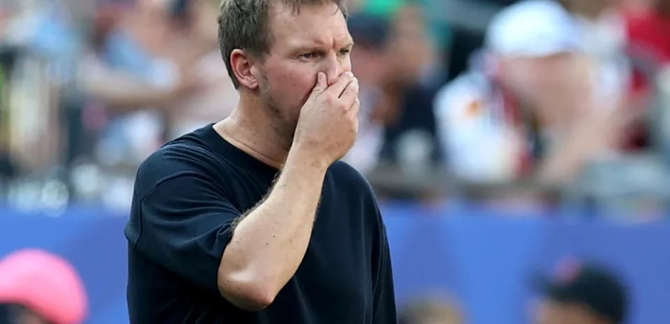 Coach observing the match with concerned expression