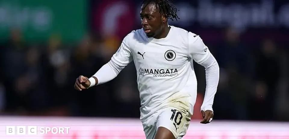 Player celebrating a goal in white kit
