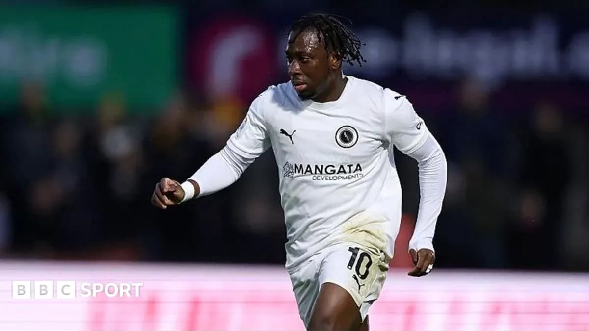 Player celebrating a goal in white kit