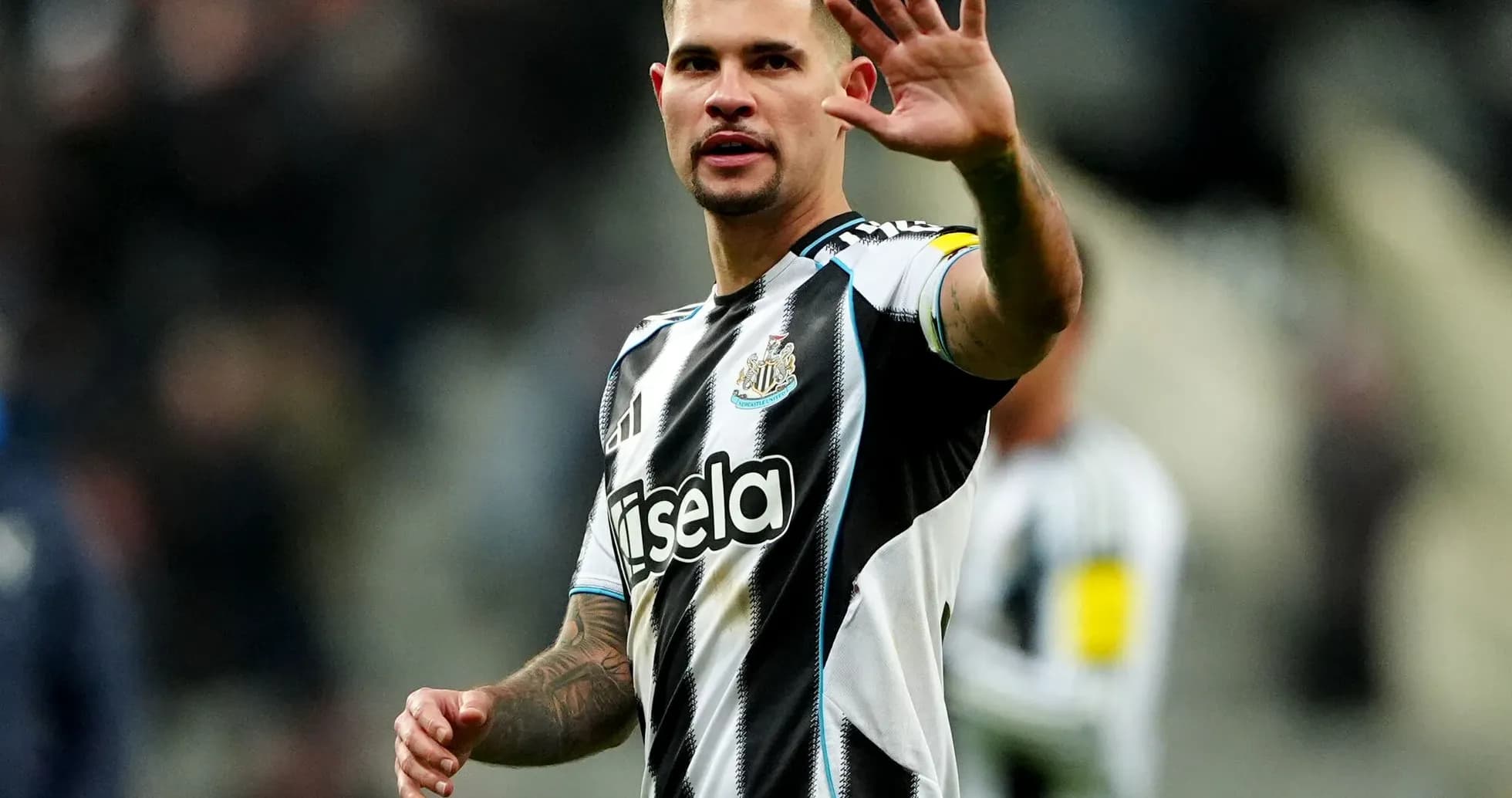 Newcastle player waving to fans during match