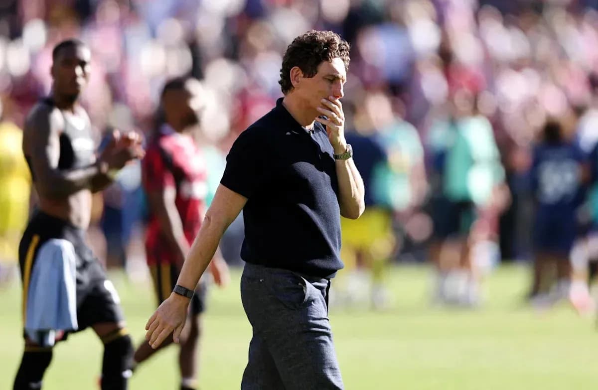 Coach walking off the pitch after the match