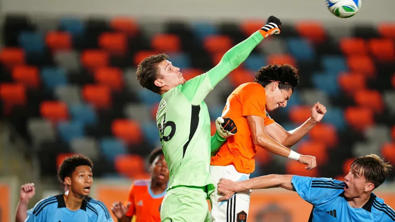 Goalkeeper punches the ball during match action
