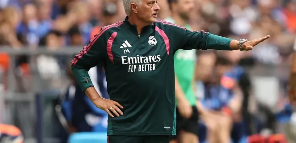 Manager directing players from the sidelines during match