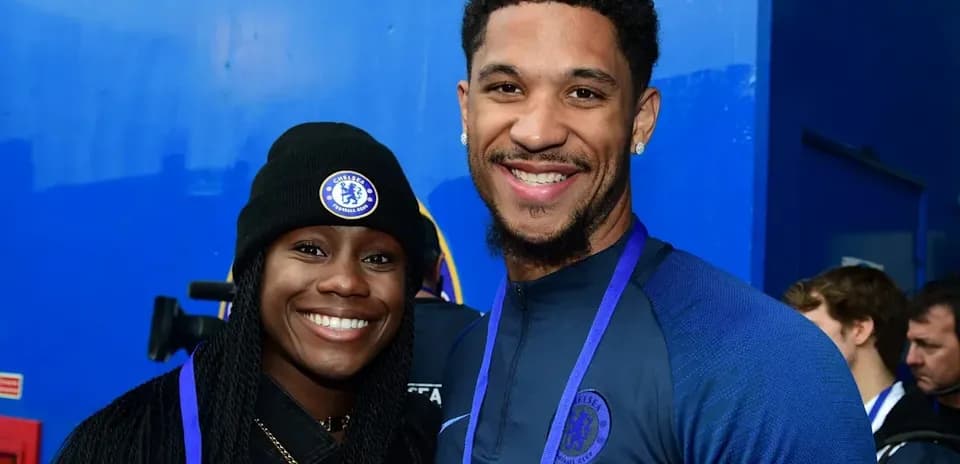 Two Chelsea FC fans posing together at event