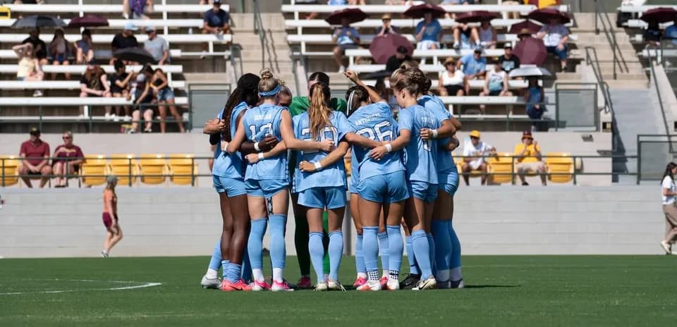 Soccer team huddled together before the match