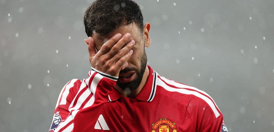 Player covering face in rain during match