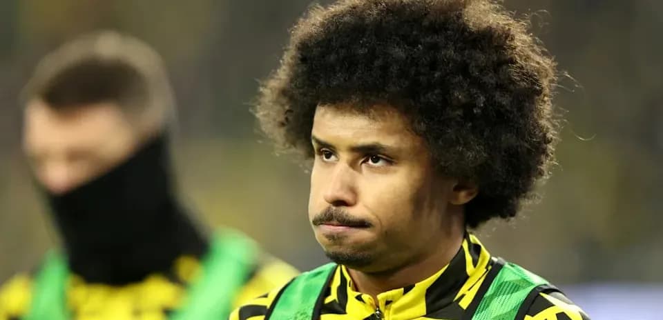 Player on the sidelines wearing team colors