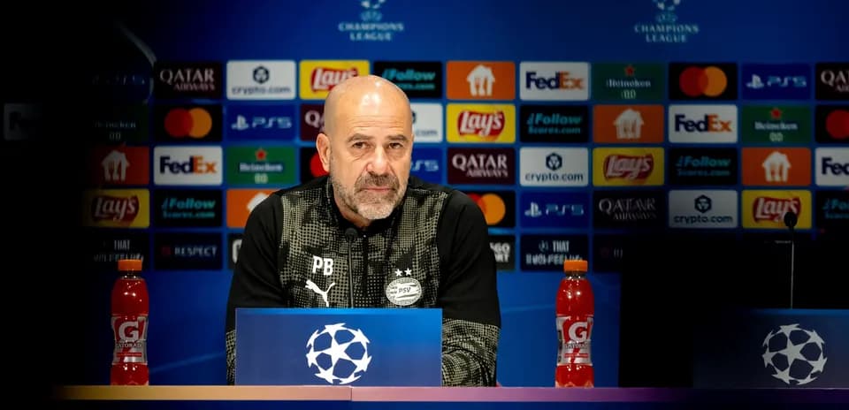 Manager at press conference with Champions League backdrop