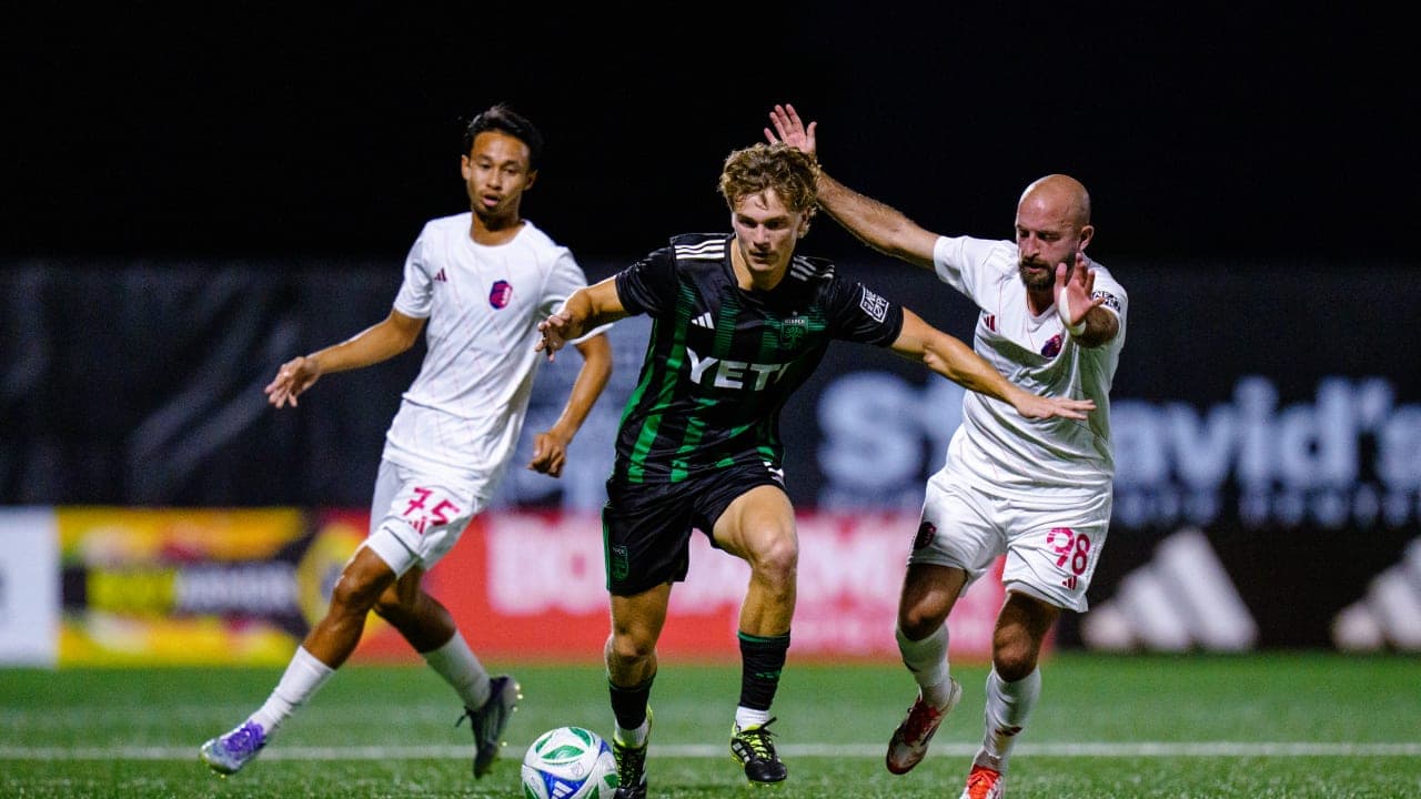 Austin II player dribbling past St. Louis City II defenders
