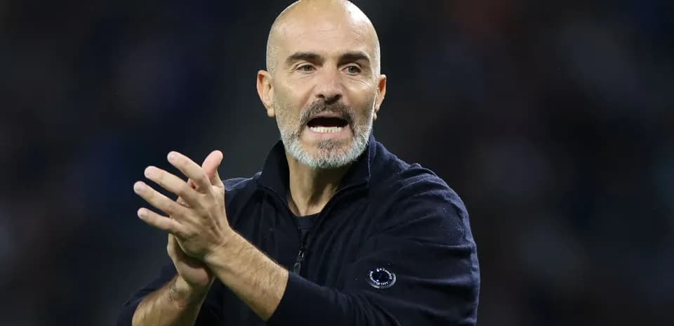 Coach gesturing and applauding during match