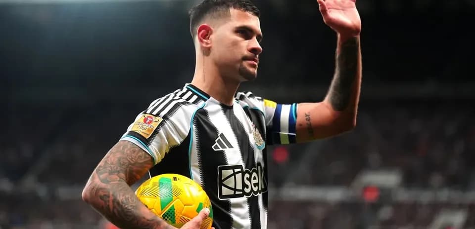 Player waving while holding a football at stadium