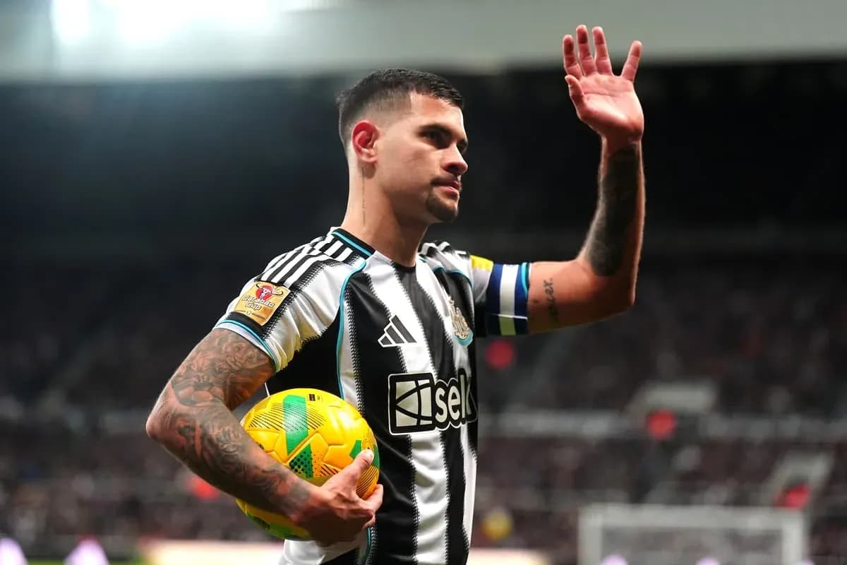 Player waving while holding a football at stadium