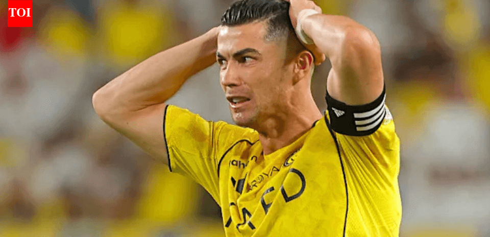 Player in yellow jersey holding head in distress
