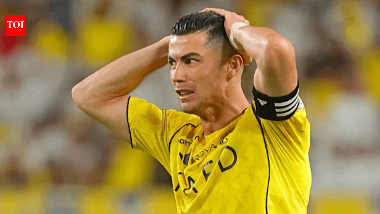 Player in yellow jersey holding head in distress
