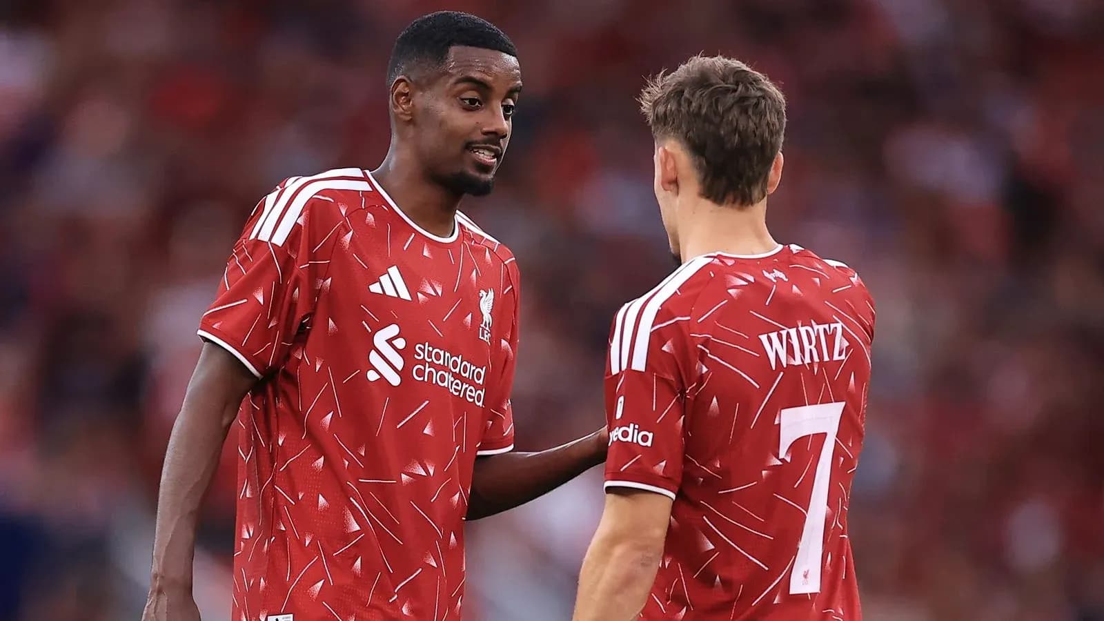 Two Liverpool players discussing during a match