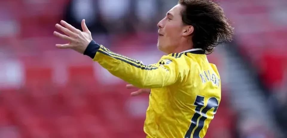 Player celebrating in yellow jersey on the field
