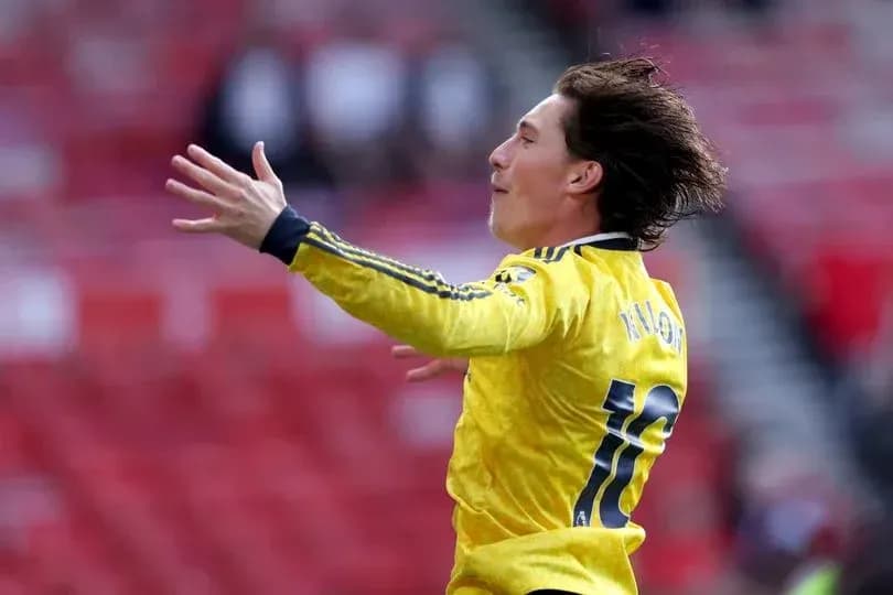 Player celebrating in yellow jersey on the field