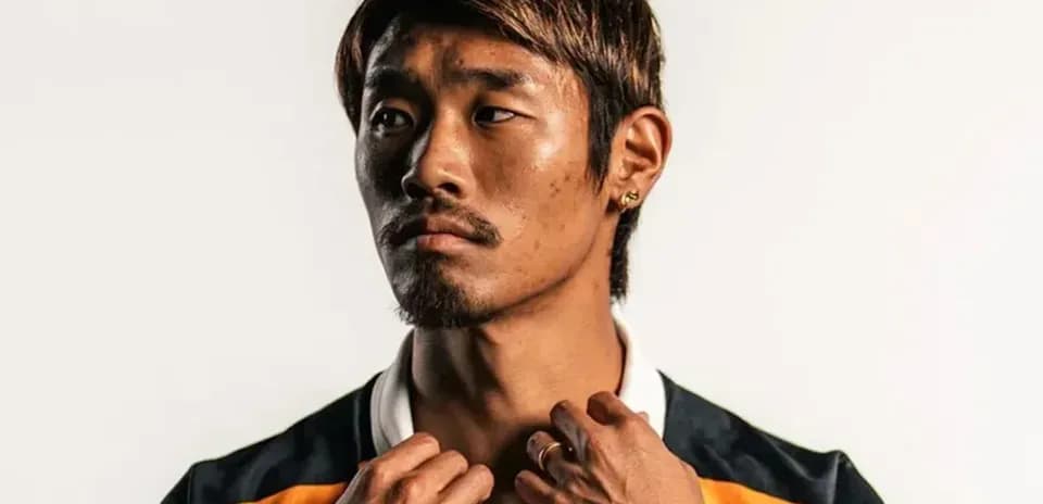 Athlete posing in team jersey with accessories
